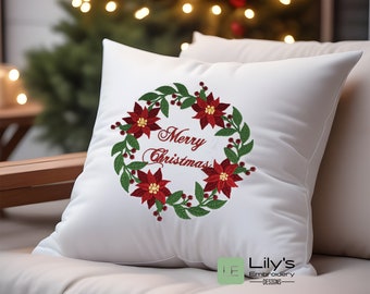 May include: White pillow with embroidered red poinsettia wreath and the text "Merry Christmas".