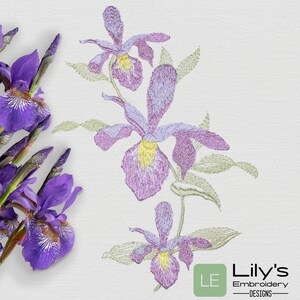 May include: Embroidered design of three purple orchids with green leaves on a white background. The design is labeled "Lily's Embroidery Designs".