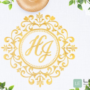 May include: Gold monogram embroidery design with the letters "HG" in a decorative frame. The design is on a white fabric background.