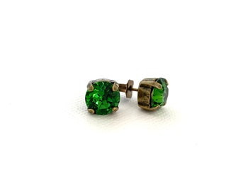May include: A pair of green gemstone earrings with antique gold-toned settings.