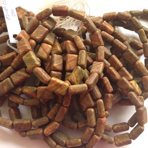May include: A strand of brown, green, and orange rectangular gemstone beads. The beads are approximately 1.2 cm long and 0.6 cm wide.