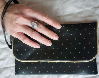 Black leather faux clutch and golden polka dots with gold piping