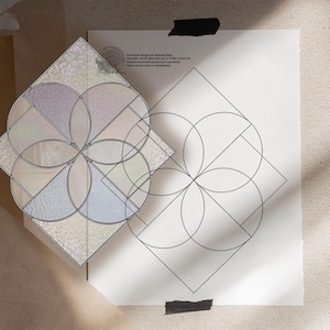 May include: A geometric design for stained glass, with overlapping circles and diamond shapes. The design is on white paper, with a finished stained glass piece in iridescent colours. The text "Geometric Design for Stained Glass" is visible.