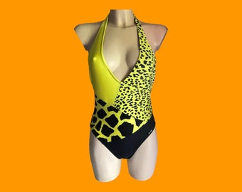 May include: A yellow and black swimsuit with a halter neck and a leopard print design.