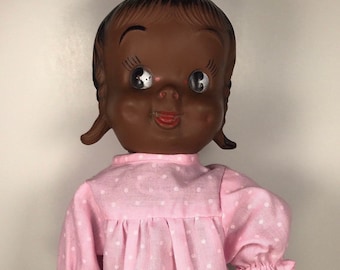 Muñeca canadiense de goma con chirrido, de los años 50, con camisón rosa.
