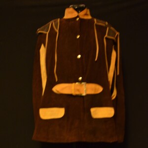 May include: A brown suede jacket with a tan leather trim and a belt. The jacket has a stand-up collar and a button closure.