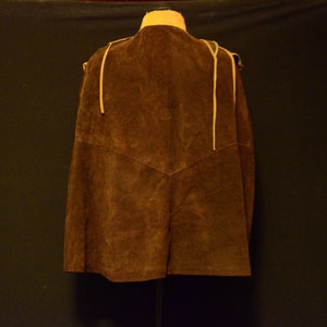 May include: A brown suede vest with a tie closure and fringe detail.