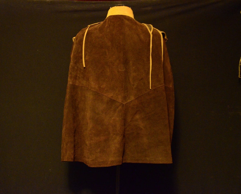 May include: A brown suede vest with a tie closure and fringe detail.
