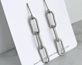 May include: Silver chain link earrings with a simple design. The earrings are displayed on a white card with the text "Wishing Flower Jewellery" and a website address.