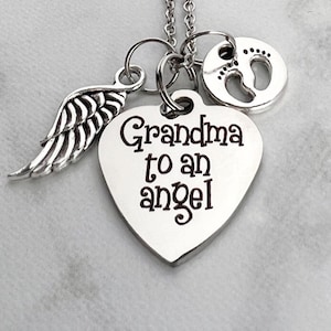 May include: Silver necklace with a heart charm that says "Grandma to an angel", a small angel wing charm, and a charm with a footprint design.