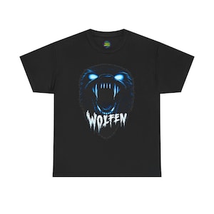 May include: A black short-sleeved t-shirt featuring a graphic of a snarling wolf head with glowing blue eyes and sharp teeth. Below the wolf head, the word WOLFEN is printed in a jagged, white, distressed font style on the centre of the chest.