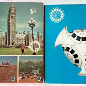 May include: A blue box containing a white View-Master reel. The box features a picture of the Canadian Parliament building on the front. The text on the box reads "21 Talking View-Master Pictures".