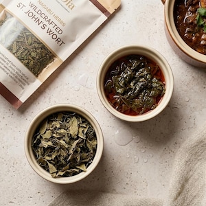 May include: A trio of ceramic mugs with a speckled, matte finish in cream, light grey, and dark grey. Each mug features a simple, minimalist design, ideal for tea or coffee.