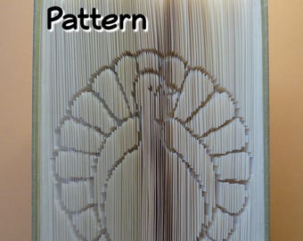 May include: A book with the word "Pattern" printed on the front cover. The pages of the book are folded to create a 3D design of a turkey.