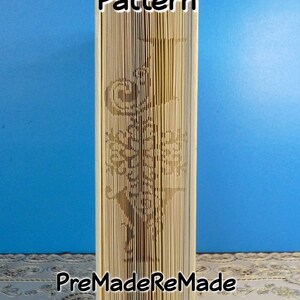 May include: A book with a folded paper design of a scorpion. The book is standing upright on a white lace tablecloth. The text "Pattern" is printed on the spine of the book. The text "PreMadeReMade" is printed below the book. The text "www.etsy.com/shop/premaderemade" is printed below the text "PreMadeReMade". A red ladybug is sitting on the tablecloth in front of the book.