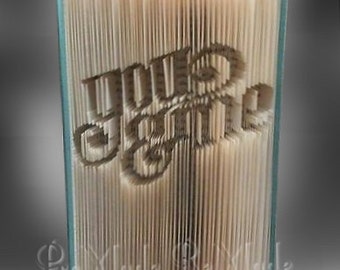 May include: A book with the word "You Are" folded into the pages. The book is bound in a blue cover and has a white interior.