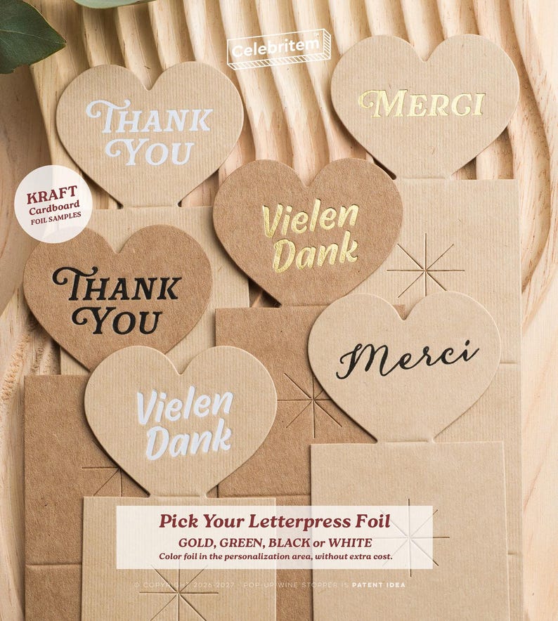 May include: Kraft cardboard heart-shaped samples with foil lettering. The hearts say "Thank You", "Merci", and "Vielen Dank" in various fonts and colors. The text "Pick Your Letterpress Foil" is also visible.