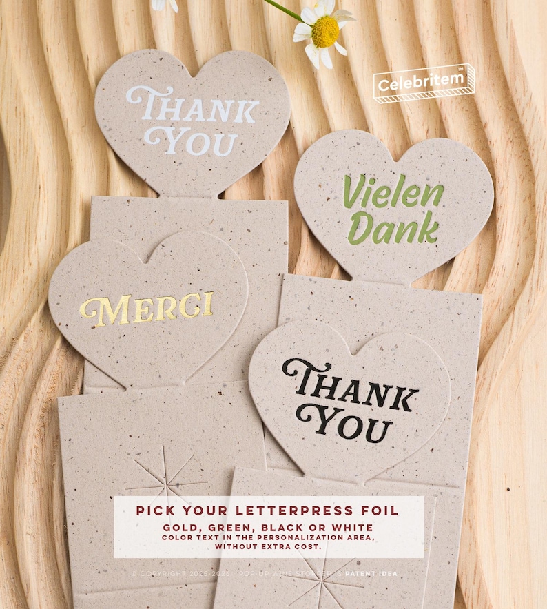 May include: Heart-shaped thank you cards with various text in white, gold, green, and black. The cards are on a textured beige background. The text "Pick your letterpress foil" is also visible.