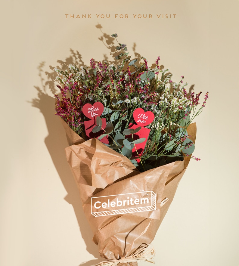 May include: A bouquet of dried flowers wrapped in brown paper, featuring red heart-shaped cards that read "Thank You" and "With love." The bouquet includes purple and white flowers and green eucalyptus leaves. The text "Thank you for your visit" is at the top.