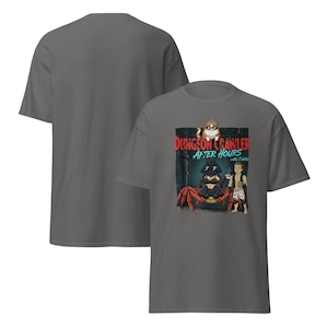 May include: Dark gray t-shirt featuring a graphic design with the text "DUNGEON CRAWLER AFTER HOURS". The design includes a cartoon crab, a cat wearing sunglasses, and a person holding a drink.