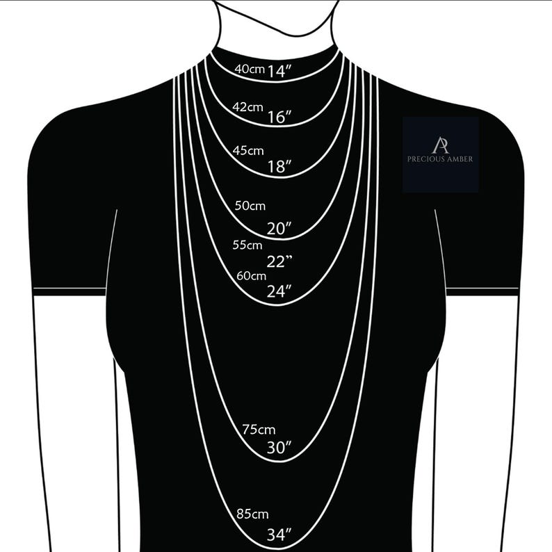 May include: A black and white illustration of a person wearing a necklace with different lengths marked in centimeters and inches. The lengths are 40cm (14 inches), 42cm (16 inches), 45cm (18 inches), 50cm (20 inches), 55cm (22 inches), 60cm (24 inches), 75cm (30 inches), and 85cm (34 inches). The text "A PRECIOUS AMBER" is also visible in the image.