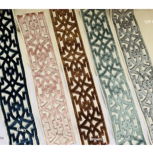 May include: Five samples of trim fabric with a geometric pattern. The trim is shown in white, navy, pink, brown, mist blue, and grey.