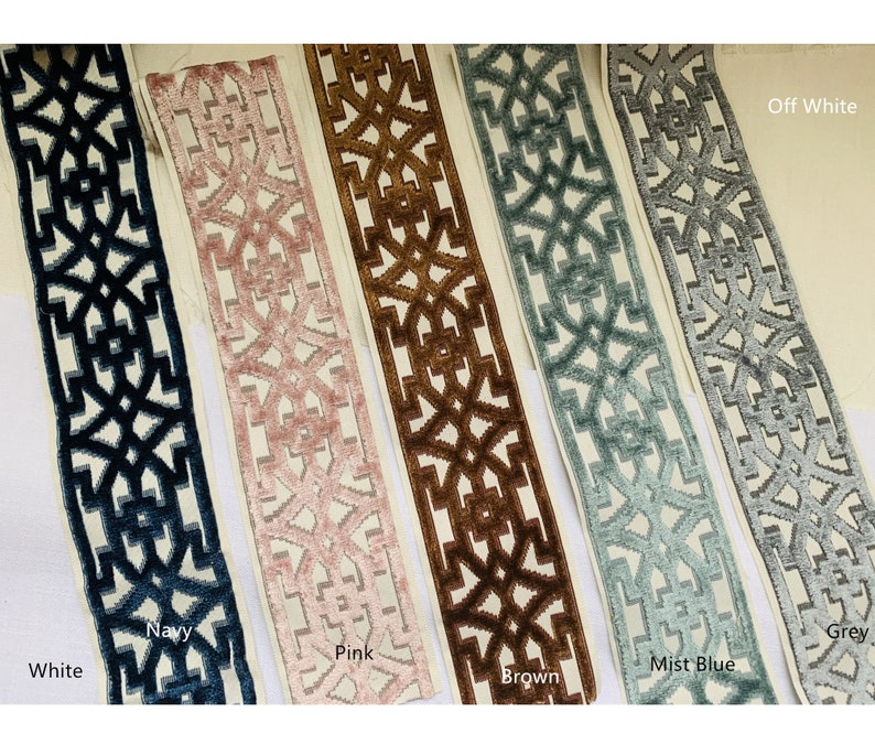 May include: Five samples of trim fabric with a geometric pattern. The trim is shown in white, navy, pink, brown, mist blue, and grey.