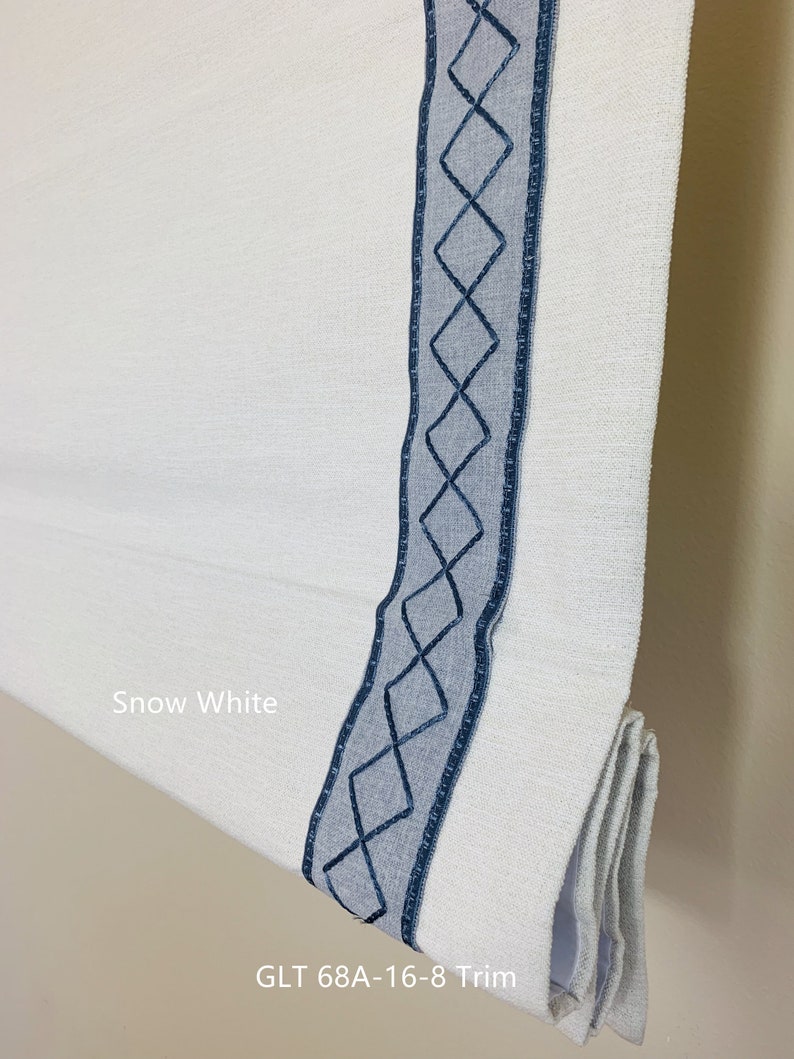 May include: Snow white roman shade with a blue diamond pattern trim. The shade is labeled "GLT 68A-16-8 Trim".