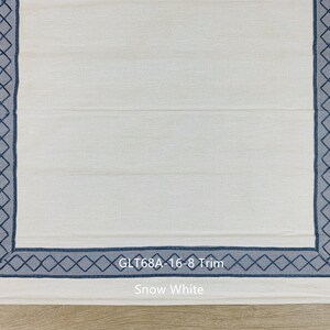 May include: White fabric with a blue diamond pattern border. The fabric is labeled "GLT68A - 16-8 Trim" and "Snow White".
