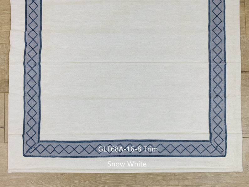 May include: White fabric with a blue diamond pattern border. The fabric is labeled "GLT68A - 16-8 Trim" and "Snow White".