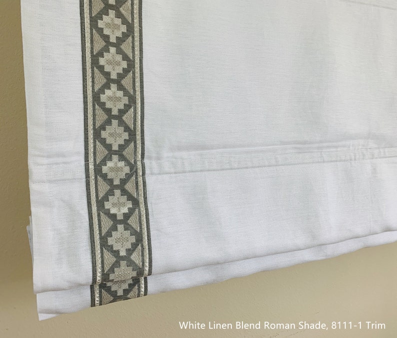 May include: White linen blend Roman shade with a gray and white geometric trim. The shade is fully extended and shows the fabric texture.