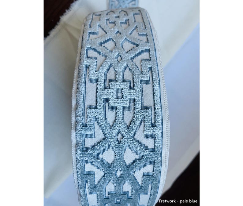May include: Pale blue trim with a white background and a geometric pattern. "Fretwork - pale blue" is written below the trim.