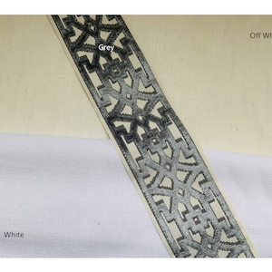May include: A close-up of a grey and white patterned trim with a geometric design. The trim is on a white and off-white fabric background.  The text "Grey" and "Off White" are visible in the image.