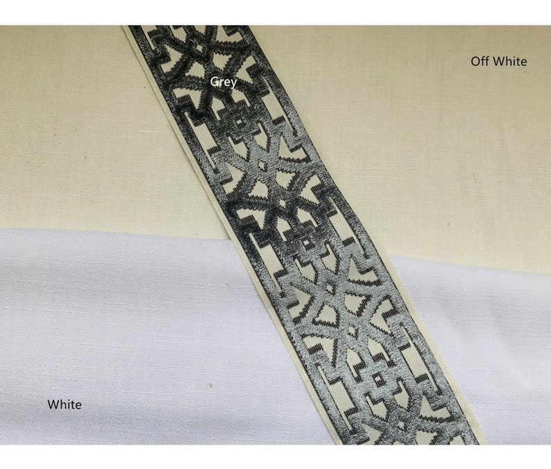 May include: A close-up of a grey and white patterned trim with a geometric design. The trim is on a white and off-white fabric background.  The text "Grey" and "Off White" are visible in the image.