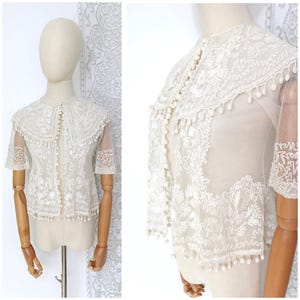 Antique 1910s French Edwardian Victorian Off-White Netting Embroidered Lace Half Sleeve Blouse Jacket With Pom Pom Fringing