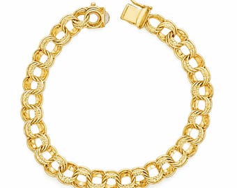 May include: A gold chain bracelet featuring a series of interlocking circular links with a textured, patterned finish on the surface of each link. The bracelet is secured with a rectangular box clasp mechanism that is currently open.