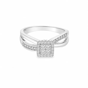 May include: A silver-toned ring featuring a square-shaped center setting composed of four small round stones surrounded by a halo of tiny clear stones. The band has a split-shank design with additional small clear stones embedded along the sides.