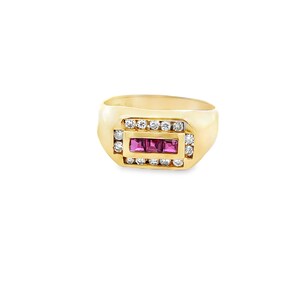 May include: A gold ring with a rectangular center featuring three pink gemstones. The center is framed by a row of small, clear gemstones, with additional clear gemstones on the top and bottom of the rectangular design.