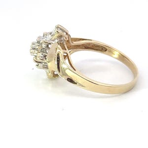 May include: A gold ring with a cluster of small diamonds set in a floral design.