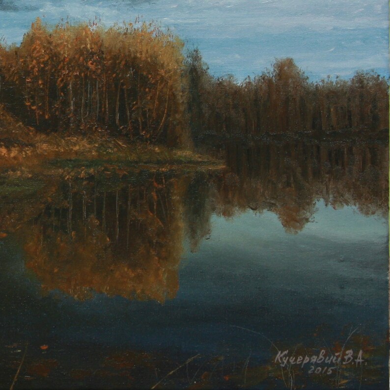 Pu&ograve; includere: Dipinto a olio di un paesaggio sereno con un lago riflettente. L'opera raffigura alberi con fogliame autunnale in tonalit&agrave; marroni e dorate, specchiati nell'acqua. Il cielo &egrave; di un azzurro tenue e il dipinto &egrave; firmato e datato 2015.