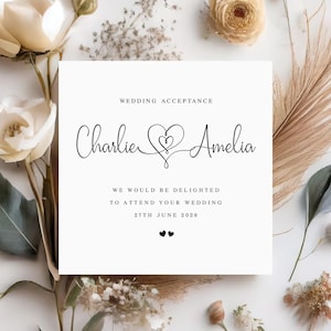 May include: Wedding acceptance card with the names Charlie and Amelia, a heart design, and the text "We would be delighted to attend your wedding 27th June 2026".