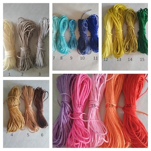 May include: Twenty spools of embroidery floss in various colors, including white, beige, brown, blue, yellow, green, purple, pink, orange, and red.