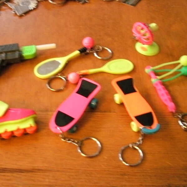 8 Vintage 1990s 80s Bright Plastic Keychains Skateboards Inline Skates Tennis Rackets Water Blaster Fan and More