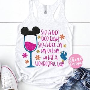 May include: A white tank top with a graphic of a wine glass with Mickey Mouse ears and the text "Sip-a-dee Doo-dah Sip-a-dee-ay My oh my, What a Wonderful Day".