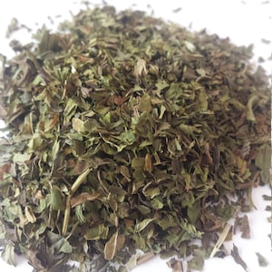 May include: A pile of dried green mint leaves.