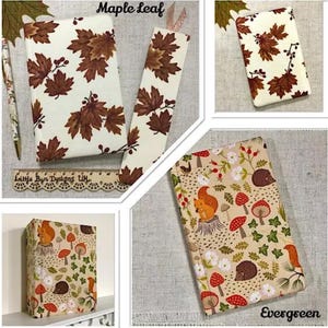 May include: A collection of notebooks and a bookmark with autumn-themed designs. One set features brown maple leaves on a cream background. Another set showcases a squirrel, mushrooms, and foliage on a tan background. The text "Maple Leaf" and "Evergreen" are visible.
