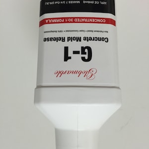 May include: White plastic bottle labeled "Globmarble G-1 Concrete Mold Release". The bottle is a concentrated 30:1 formula, non-petroleum based, super concentrated, and 100% biodegradable. It makes 7 3/4 gallons (29.3 liters) from 32 fluid ounces (946 milliliters).