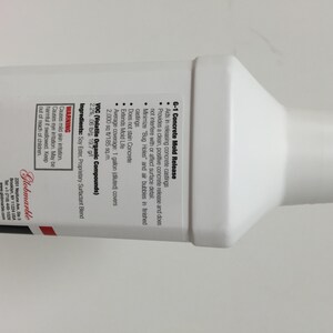 May include: A white plastic bottle of G-1 Concrete Mold Release. The bottle has a red label with black text that reads "G-1 Concrete Mold Release" and lists the product's features and ingredients. The label also includes a warning about skin and eye irritation.
