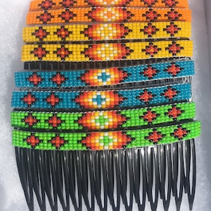 May include: A set of eight beaded hair combs with colorful geometric patterns. The combs are black and have a row of teeth on the bottom.