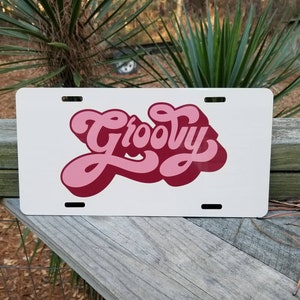 Aesthetic Groovy Hippie Retro license plate. Cream and peachy pink groovy text. Funky. Front license plate car tag. Name plate, Vanity